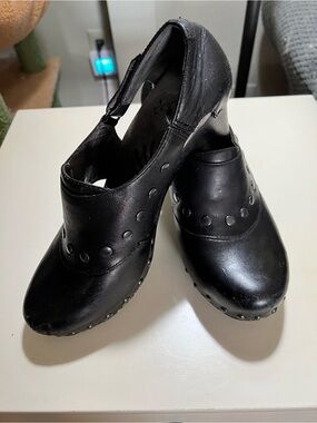 Dansko Ryder Black Leather clogs with silver studded details and block heels.